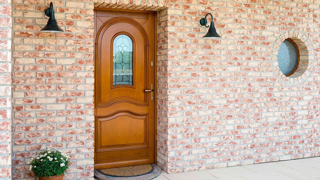 Beautiful  north jersey entryway with glass pane in center and brick surrounding. Custom mahogany exterior doors.