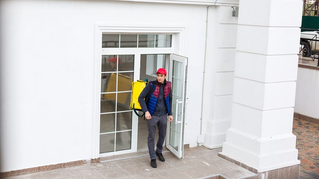 Delivery person going out using an outward swinging exterior door