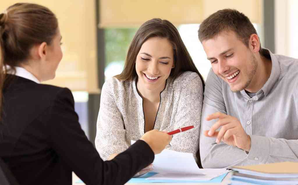 Happy couples choosing financing options in Madison Door offers