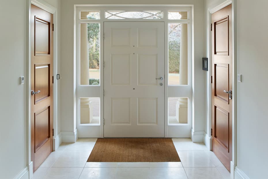 Bright entryway featuring a white front door with glass panels, ideal for homeowners choosing a front door that balances natural light and classic design.